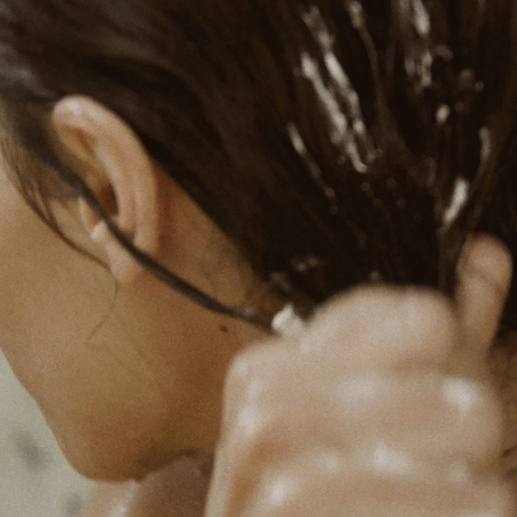 Close-up of wet hair while Blu & Green conditioner is being applied.