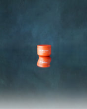 Load image into Gallery viewer, Jar of Blu & Green Solid Oil reflected on a glossy surface, minimalist product shot against a deep blue background.