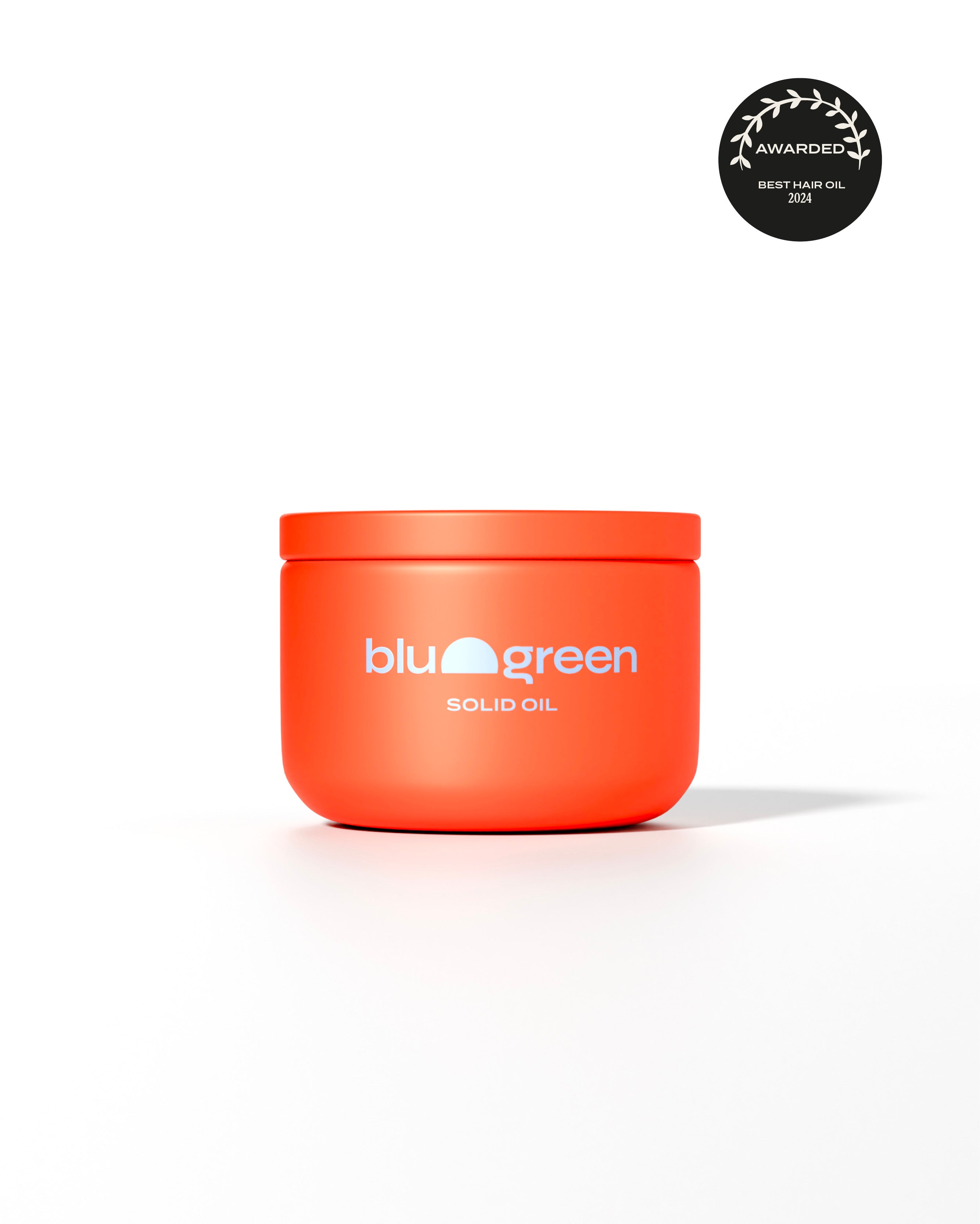Bright jar of Blu & Green Solid Oil, award-winning 2024 Best Hair Oil, in sustainable packaging.
