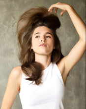 Load image into Gallery viewer, Woman in white tank top lifting her hair with volume and shine, showcasing Blu & Green Dry Shampoo results.