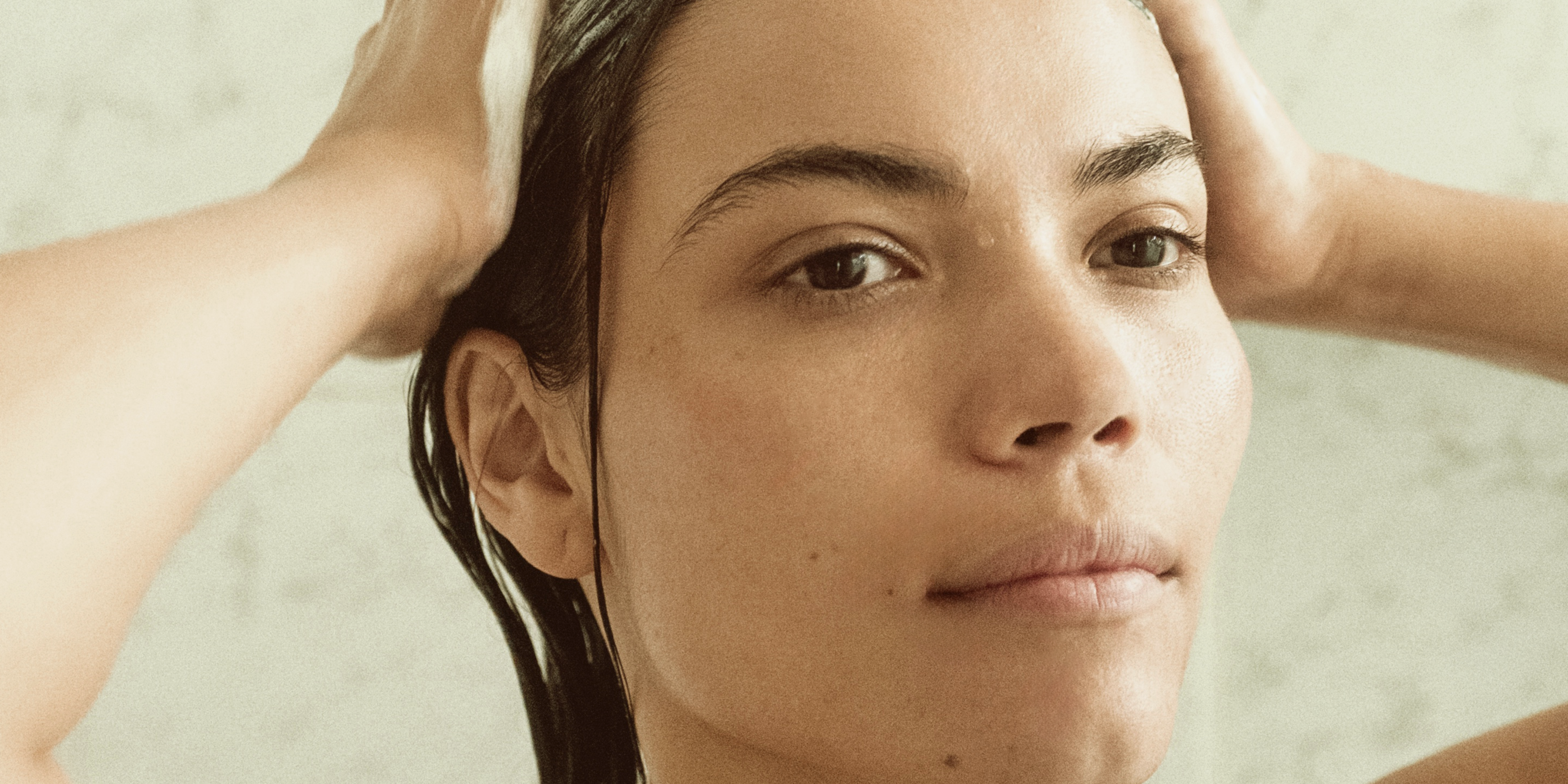 Woman washing hair with Blu & Green's Daily Shampoo Concentrate.