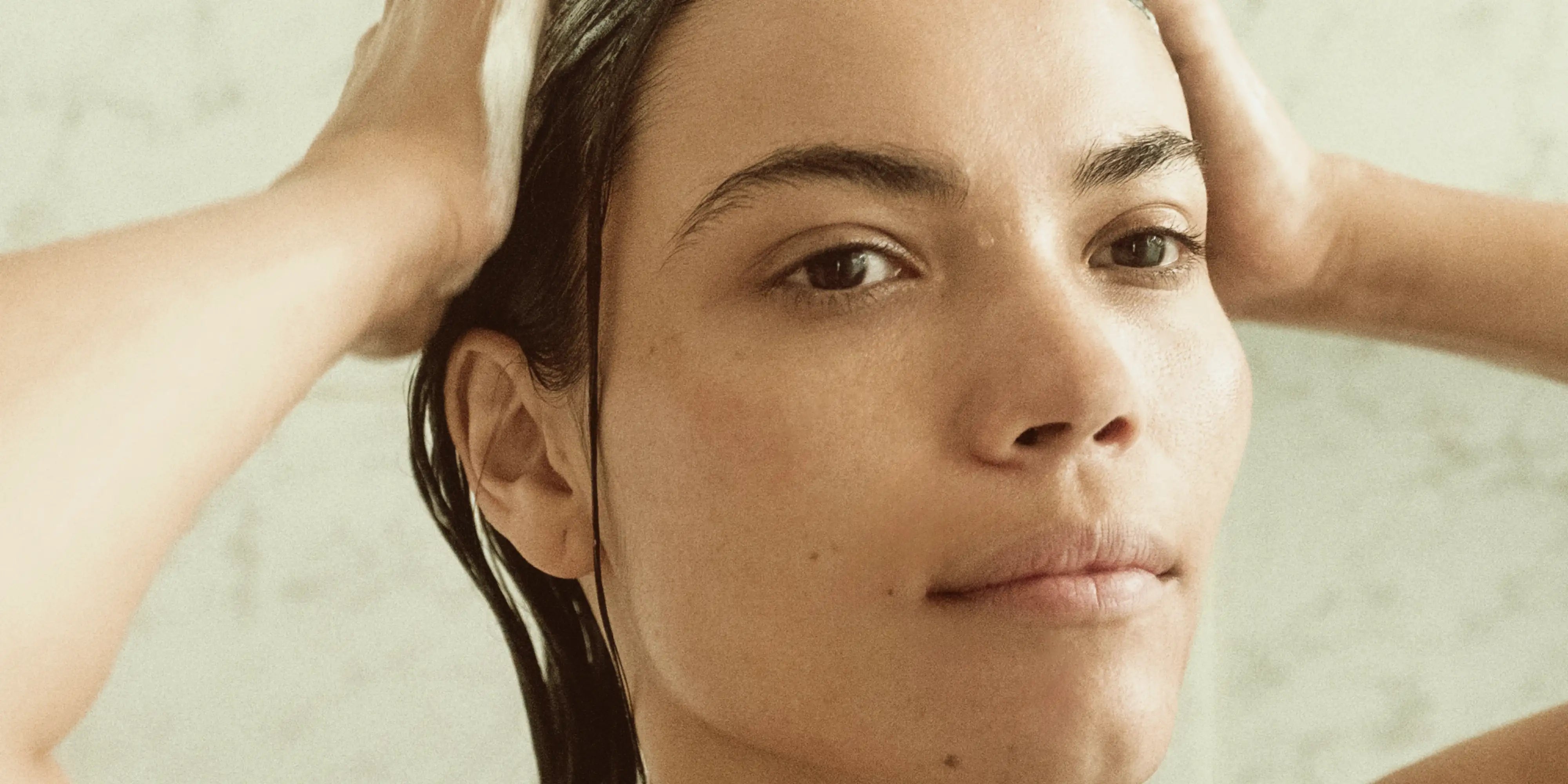Woman washing hair with Blu & Green's Daily Shampoo Concentrate.