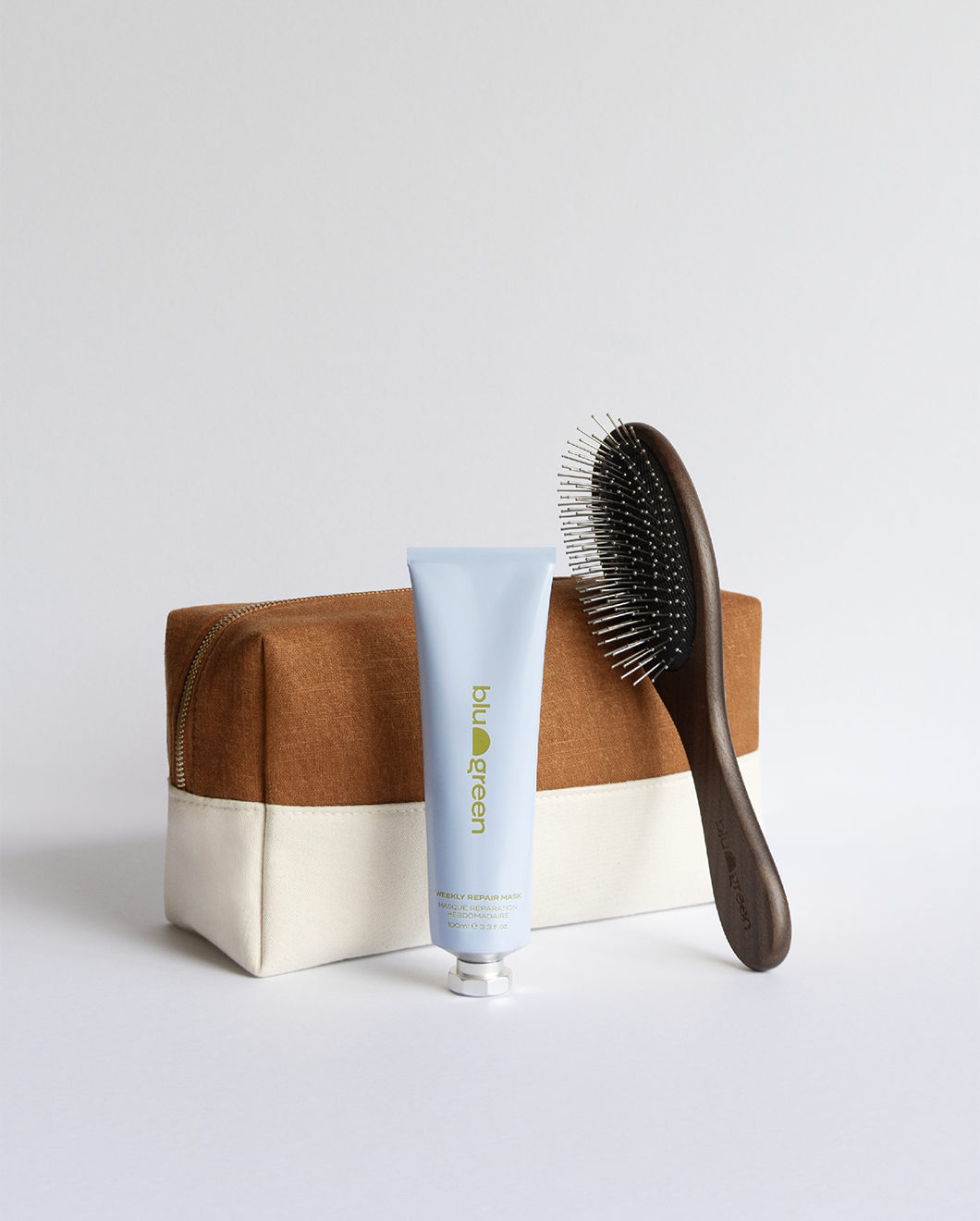 Blu & Green’s exclusive holiday Hair Repair Kit with the Weekly Repair Mask, sustainable Walnut Detangling Brush, and canvas gift bag.