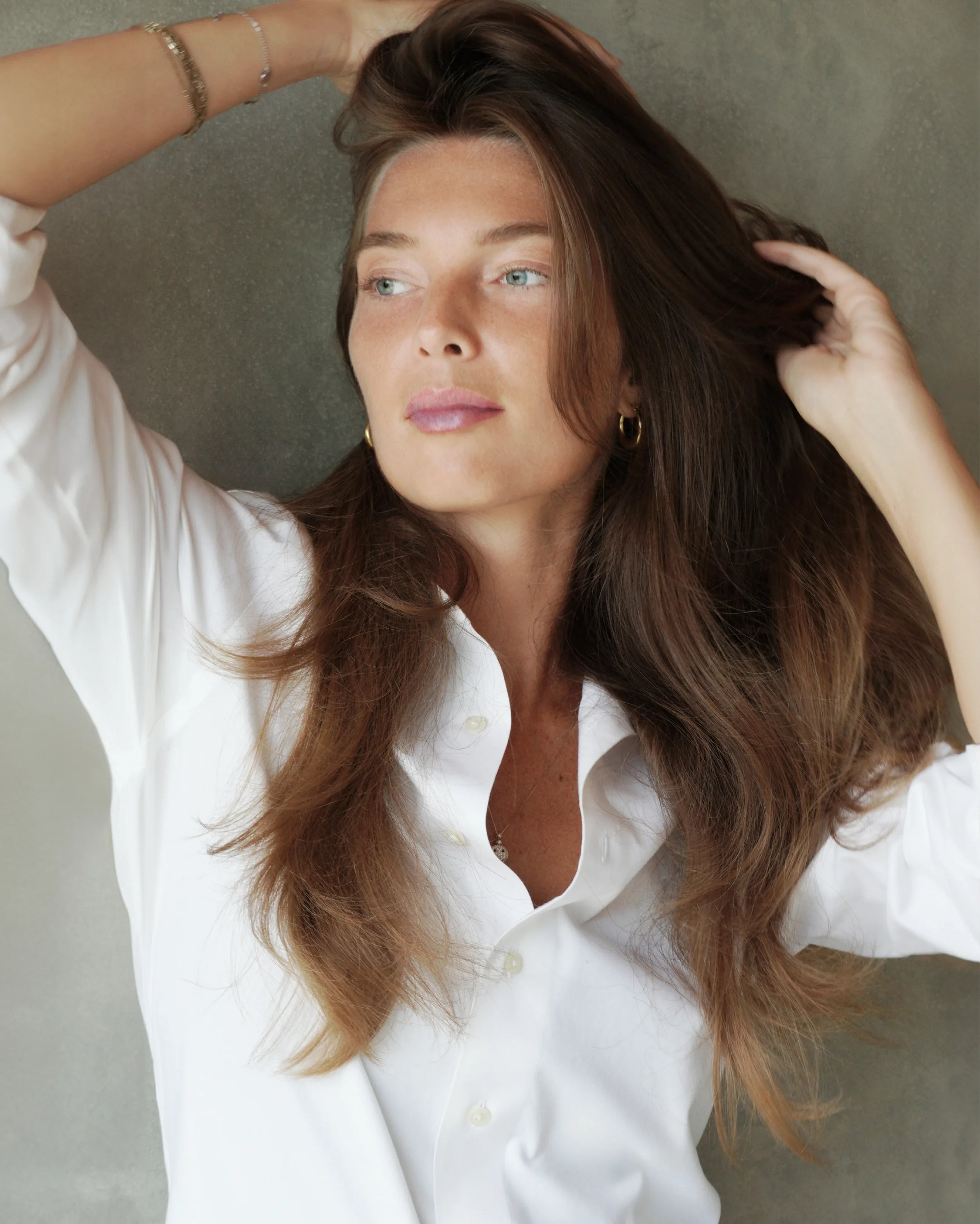 Model with voluminous, naturally dried hair styled with Rise & Set Light Styling Cream