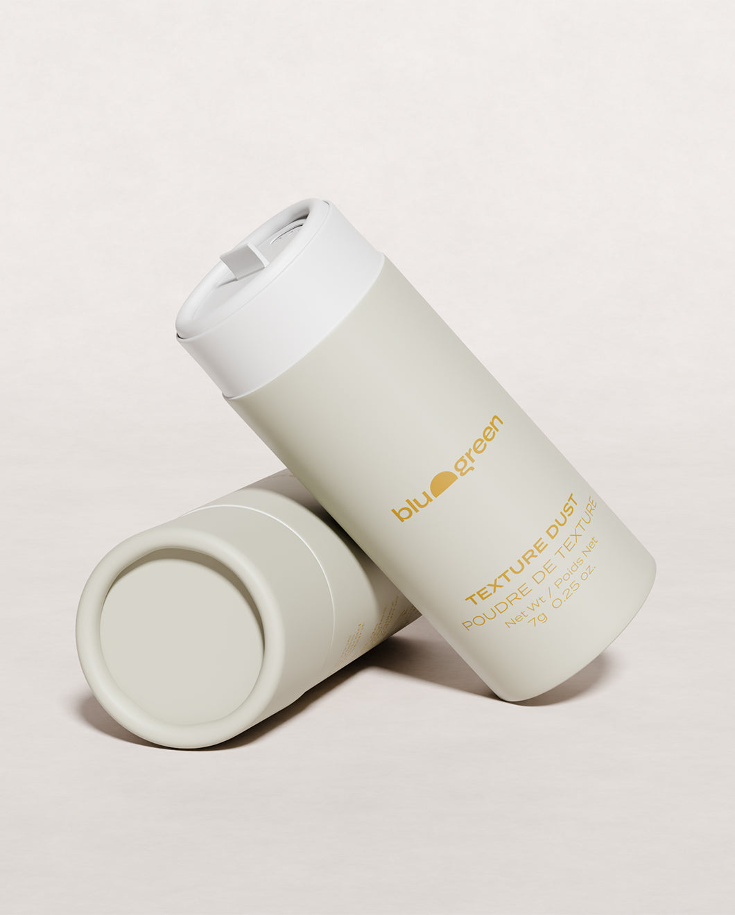 Blu & Green Texture Dust, one 7g bottle with open cap angled forward, another lying flat, eco-friendly styling powder.