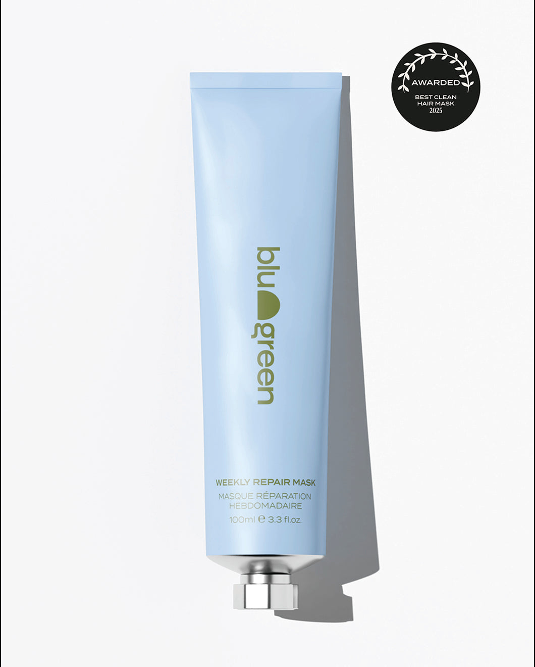 Light blue tube of Blu & Green Weekly Repair hair Mask, 100ml, shown upright with silver cap against a white background. Minimalist eco-friendly packaging with green logo and text. Award badge in corner highlights 