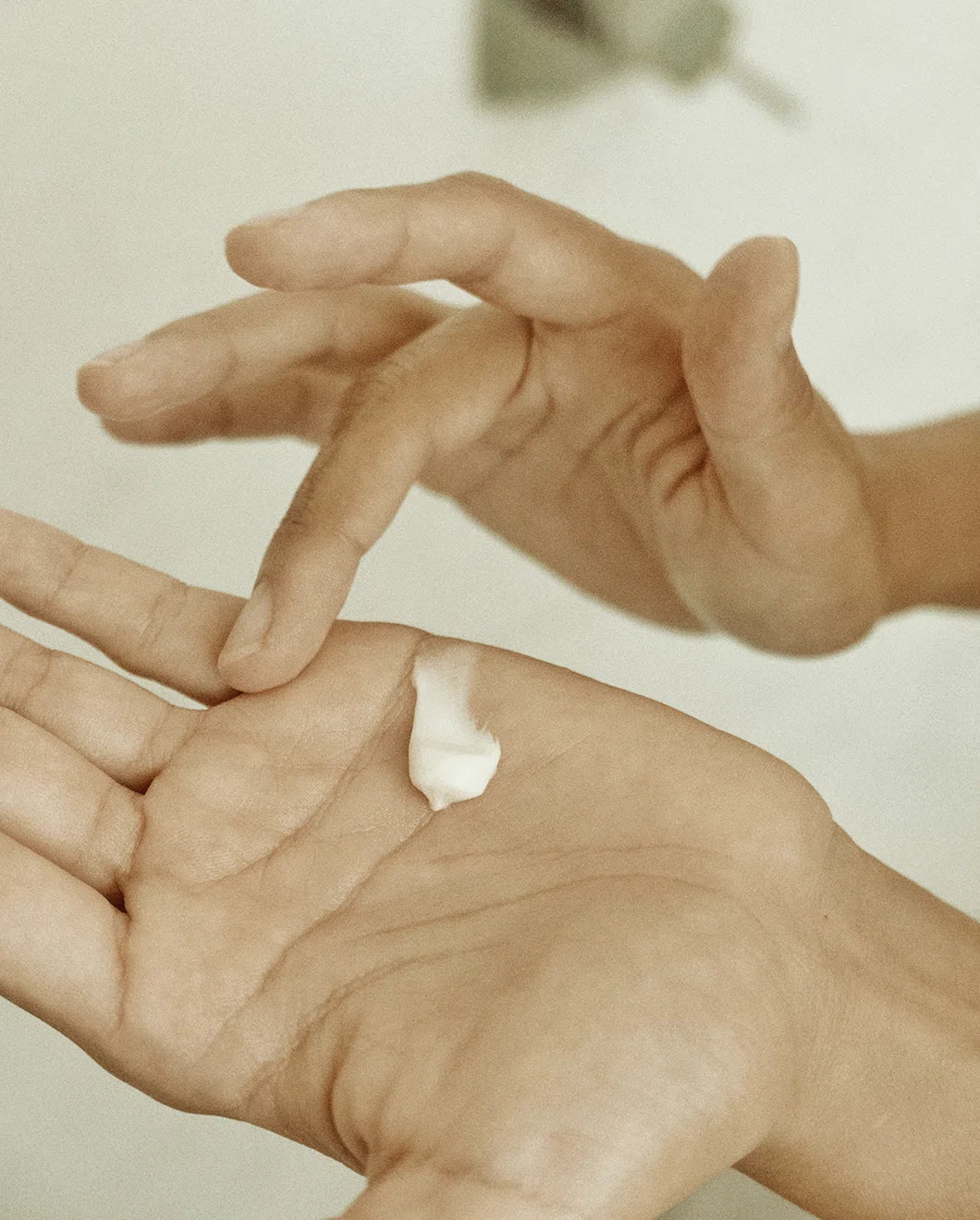 Close-up of Blu & Green Daily Conditioner Concentrate squeezed into the palm of a hand.