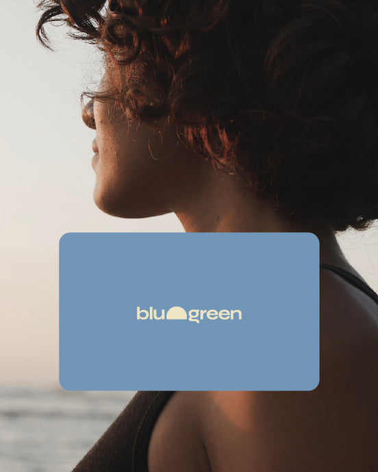 Profile of a woman gazing away. Shoulder-length curly hair. glow of the sunset. Graphic of the blu and green gift card over bottom of image.